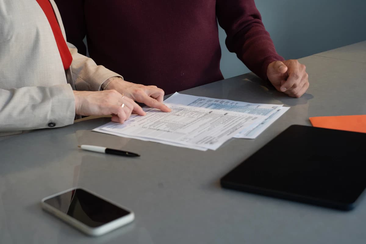 Two people reviewing shipment paperwork together at a desk