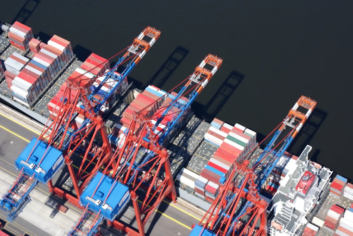 Cranes loading a container ship at berth, seen from above
